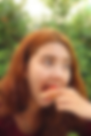 Blurred image of a woman eating pizzaの写真素材