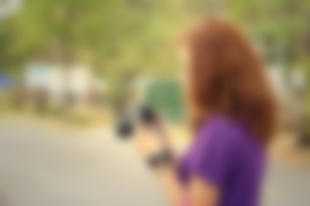 Blurred image of the female photographer at the parkの写真素材