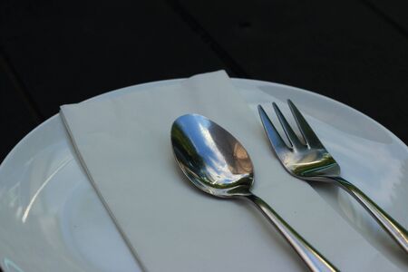 White dish with a spoon and fork.の写真素材