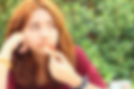 Blurred image of a woman eating pizzaの写真素材