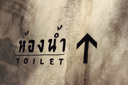 Signs to the toilet black lettering on a background of the cement.の写真素材