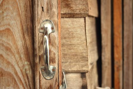 door handles on a brown wooden door.の写真素材