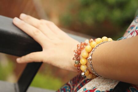 A young woman wearing a colorful bracelet.の写真素材