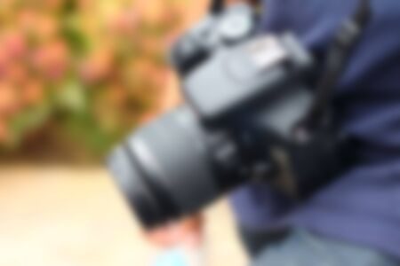blurred image of the photographer's holding a camera.の写真素材