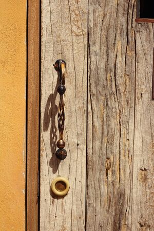 door handles on a brown wooden door.の写真素材