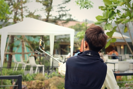 A young man taking a photo himself.