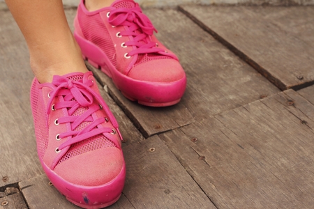Pink shoes on a brown background at the park.の写真素材