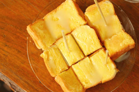 bread and butter in plate on a tableの写真素材