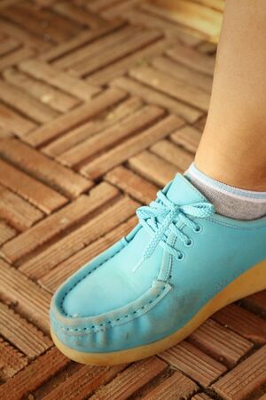 Woman wearing blue shoes at the park.の写真素材