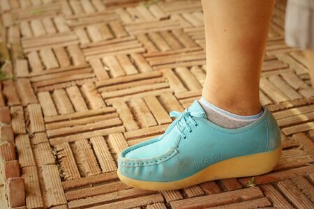 Woman wearing blue shoes at the park.