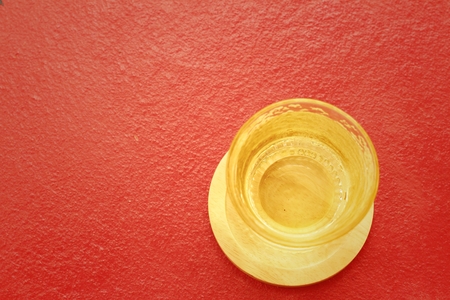 Water in a glass on a red backgroundの写真素材