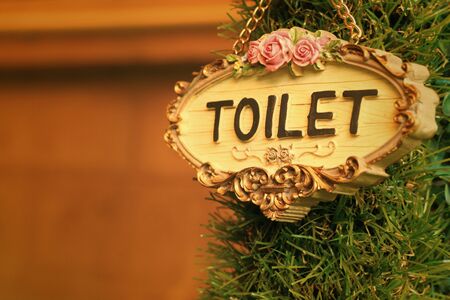 toilet vintage label on a brown background.の写真素材