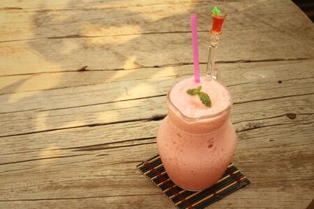Fruit smoothies in glass placed in the garden.の写真素材