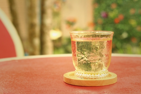 Water in a glass on a red backgroundの写真素材