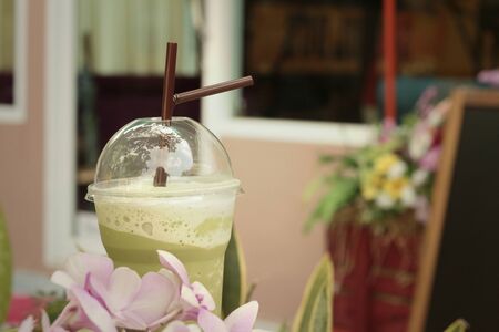 Iced green tea with flowers in the garden.