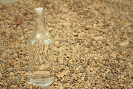 Water in bottle on  rocks.の写真素材
