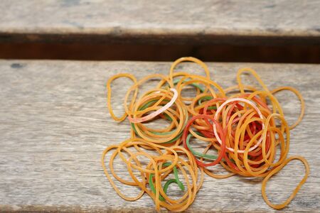 Rubber band on a wood tableの写真素材