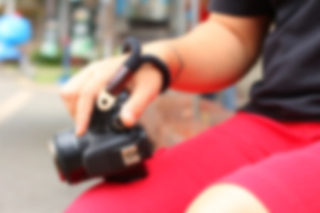 Blurred image of a woman taking photo