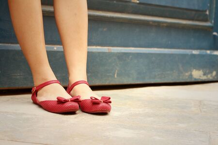 Woman wearing red shoes at the parkの写真素材