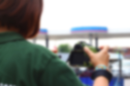 Blurred image of a woman taking photoの写真素材