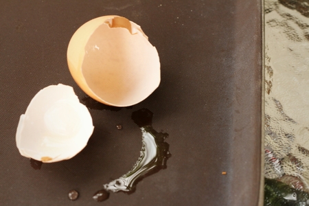 Eggshell on a brown background of table.の写真素材