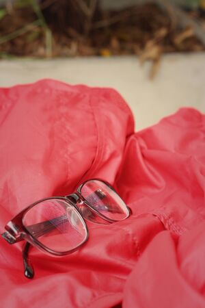 Black glasses on a background of redの写真素材