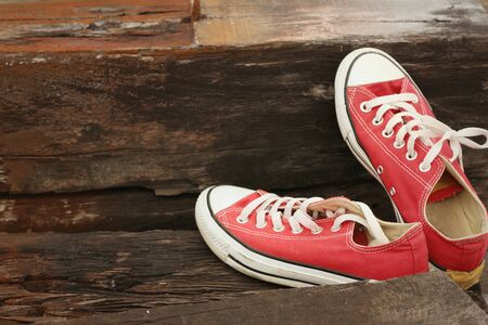 Red shoes on the floor of brown wood.の写真素材