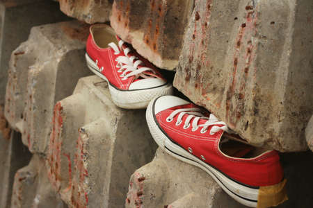 Red shoes on the floor of cement.