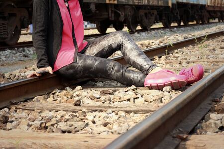Women are using a phone at train stationの写真素材