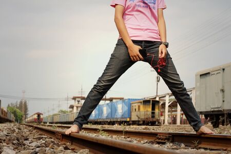Women wearing jeans holding a cell phone.の写真素材