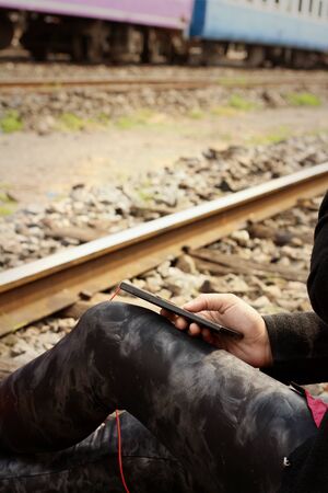 Women are using a phone at train station