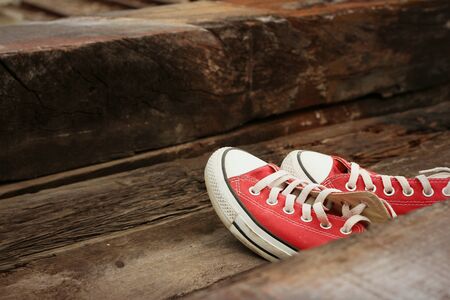 Red shoes on the floor of brown wood.の写真素材