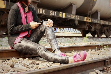 Women are using a phone at train station