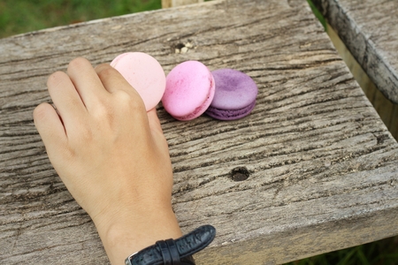 Macaroons on a wood background at the park.の写真素材