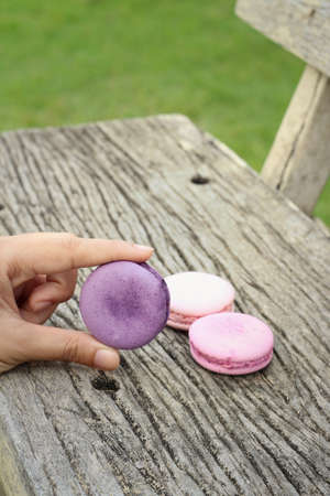 Macaroons on a wood background at the park.の写真素材