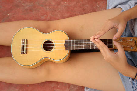 Woman playing ukulele, vintage styleの写真素材