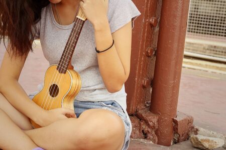 Woman playing ukulele, vintage styleの写真素材