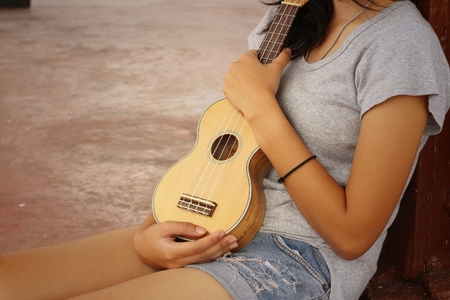 Woman playing ukulele, vintage styleの写真素材