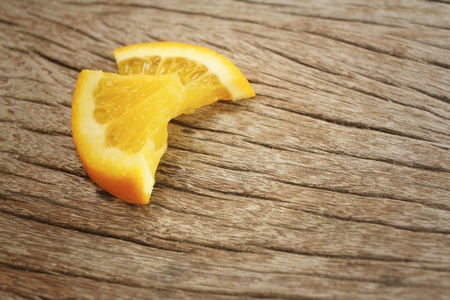 Orange on a background of brown wood.の写真素材