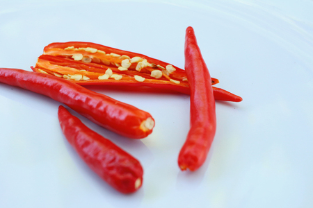 Red chili on white plate at the kitchenの写真素材