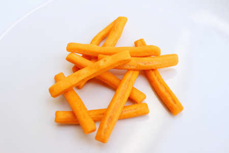bread sticks in white plate on a tableの写真素材