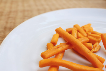 bread sticks in white plate on a tableの写真素材
