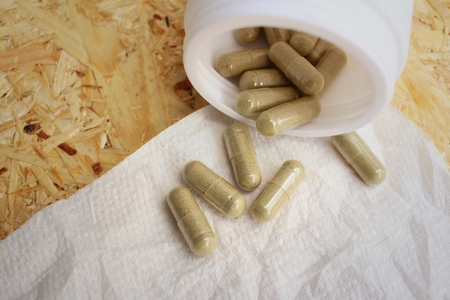 Medical pill on background of  wooden table.