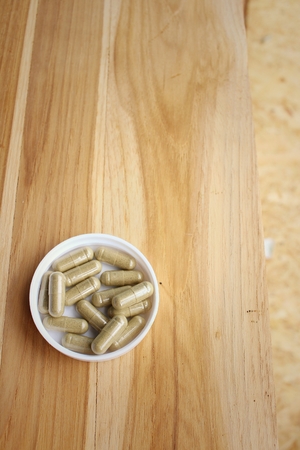 Medical pill on background of  wooden table.の写真素材