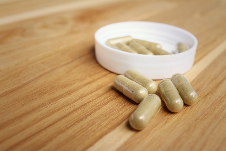 Medical pill on background of  wooden table.の写真素材