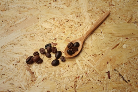coffee beans on background of brown wood.の写真素材