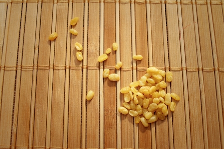 Soybeans on a background of brown woodenの写真素材