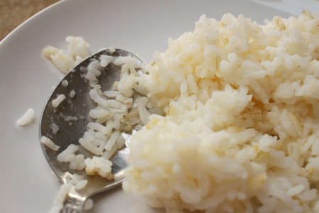 Rice on white plate on wooden background.の写真素材