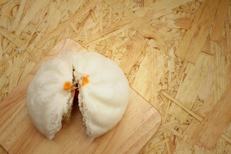 steamed dumpling - chinese bun on brown background.の写真素材