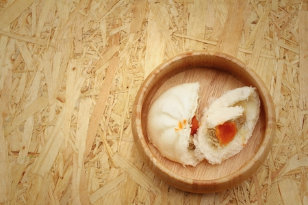 steamed dumpling - chinese bun on brown background.